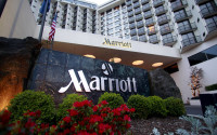 FILE - This April 20, 2011 file photo shows Portland Marriott Downtown Waterfront in Portland, Ore.  Marriott International has cleared one of its major hurdles on its journey to acquire rival Starwood and become the world's largest hotel chain. Shareholders in both Marriott and Starwood Hotels & Resorts Worldwide Inc. approved the $14.41 billion sale Friday, April 8, 2016.  (AP Photo/Rick Bowmer)