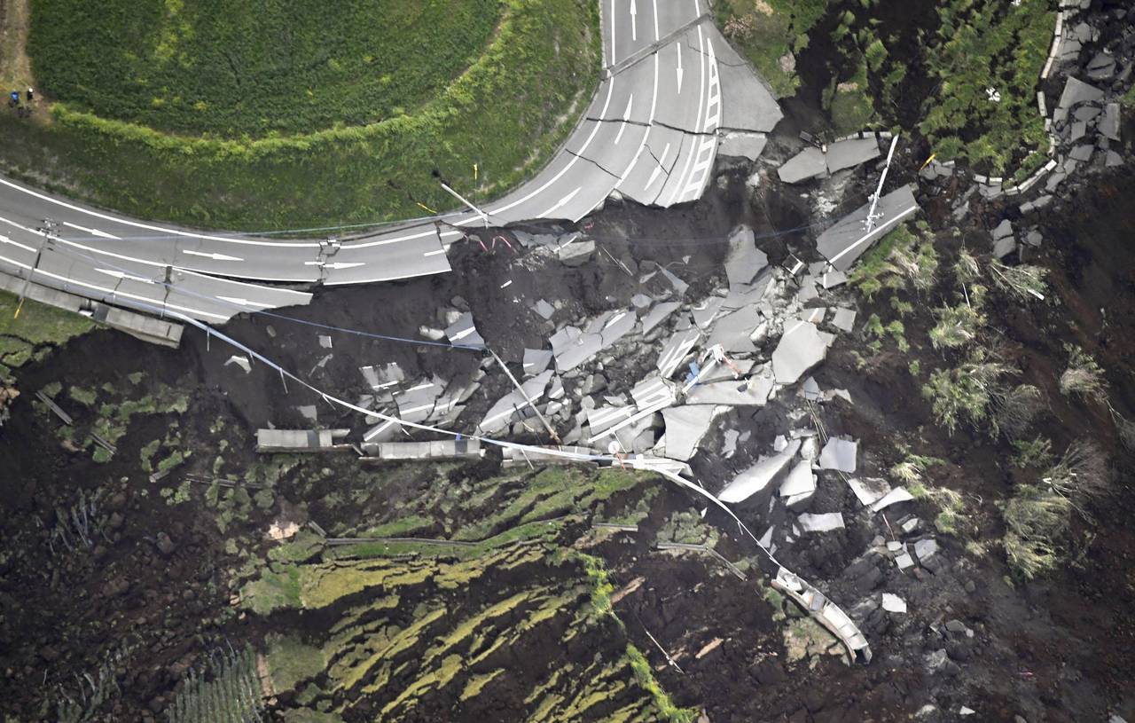 In this aerial photo, the landslide caused by the earthquake disrupts the road in Minamiaso town, Kumamoto prefecture, southern Japan Saturday, April 16, 2016. A powerful earthquake struck southern Japan early Saturday, barely 24 hours after a smaller quake hit the same region.(Kyodo News via AP) JAPAN OUT, MANDATORY CREDIT