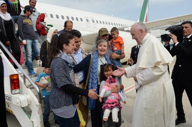 Pope Francis greets a group of Syrian refugees upon lading at Rome's Ciampino airport Saturday, April 16, 2016. Pope Francis gave Europe a provocative and concrete lesson in how to treat refugees Saturday by bringing home 12 Syrian Muslims aboard his charter plane after an emotional visit to the hard-hit Greek island of Lesbos. (Filippo Monteforte/Pool Photo via AP)