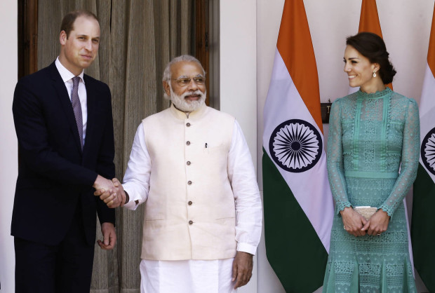 Britain's Prince William, left, and his wife Kate, the Duchess of Cambridge, right, are greeted by Indian Prime Minister Narendra Modi as they arrive for a lunch with him, in New Delhi, India, Tuesday, April 12, 2016.  The Duke and Duchess of Cambridge are on a weeklong visit to India, their first royal tour in two years. (AP Photo/Saurabh Das)