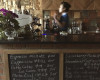 In this Thursday, March 31, 2016 photo, a waitress works behind the counter at the Kumrung coffee shop, one of Pyongyang's newest and popular coffee shops, in North Korea. Pyongyang may be one of the few major cities left on Earth where you can't find a Starbucks, but it's brimming over with coffee shops. (AP Photo/Eric Talmadge)