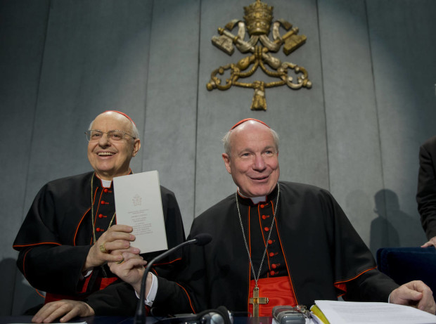 Cardinals Lorenzo Baldisseri, left, and Christoph Schoenborn show a copy of the post-synodal apostolic exhortation ' Amoris Laetitia ' (The Joy of Love) during a press conference at the Vatican, Friday, April 8, 2016. Pope Francis has insisted that individual conscience be the guiding principle for Catholics negotiating the complexities of sex, marriage and family life in a major document released Friday that repudiates the centrality of black and white rules for the faithful. In the 256-page document "The Joy of Love," released Friday, Francis makes no change in church doctrine. (AP Photo/Andrew Medichini)