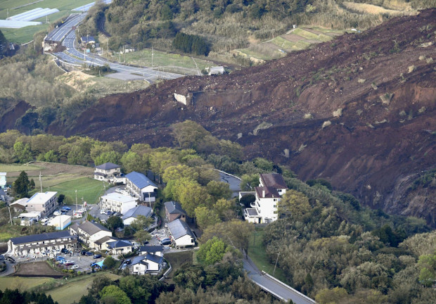 In this aerial photo, the landslide caused by the earthquake disrupts the road in Minamiaso town, Kumamoto prefecture, southern Japan Saturday, April 16, 2016. A powerful earthquake struck southern Japan early Saturday, barely 24 hours after a smaller quake hit the same region.(Muneyuki Tomari/Kyodo News via AP) JAPAN OUT, MANDATORY CREDIT