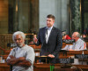 Neb. state Sen. Beau McCoy of Omaha, center, speaks during a debate in Lincoln, Neb., Tuesday, April 12, 2016, on a proposal to reinstate a winner-take-all system for Nebraska's five presidential electoral votes, with Sen. Ernie Chambers of Omaha, left, and Sen. John Murante of Gretna, right, listening. The measure has failed in the Legislature after supporters failed to overcome a filibuster , thwarting a Republican attempt to increase the chances of their 2016 presidential nominee winning all five of the state's votes. (AP Photo/Nati Harnik)