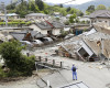Resident houses are seen destroyed after an earthquake in Mashiki, Kumamoto prefecture, southern Japan, Saturday, April 16, 2016. Powerful earthquakes a day apart shook southern Japan, trapping many beneath flattened homes and sending thousands to seek shelter in gymnasiums and hotel lobbies. (Yusuke Ogata/Kyodo News via AP) JAPAN OUT, MANDATORY CREDIT