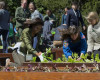 First lady Michelle Obama, left, with NASA Deputy Administrator Dava Newman, right, astronaut Cady Coleman, center, and students from across the country, plant vegetables during the eight annual White House Kitchen Garden planting on the South Lawn of the White House in Washington, Tuesday, April 5, 2016. (AP Photo/Pablo Martinez Monsivais)