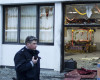 A police officers stand passes by a Sikh temple after three people have been injured in an apparently deliberate explosion Saturday evening, April 16, 2016 in the western German city of Essen.  A spokesman for Essen police told The Associated Press that a masked person is reported to have fled the scene shortly after the blast. (Marcel Kusch/dpa via AP)
