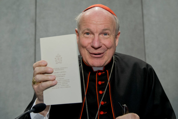 Cardinal Christoph Schoenborn shows a copy of the post-synodal apostolic exhortation ' Amoris Laetitia ' (The Joy of Love) during a press conference at the Vatican, Friday, April 8, 2016. Pope Francis has insisted that individual conscience be the guiding principle for Catholics negotiating the complexities of sex, marriage and family life in a major document released Friday that repudiates the centrality of black and white rules for the faithful. In the 256-page document "The Joy of Love," released Friday, Francis makes no change in church doctrine. (AP Photo/Andrew Medichini)