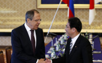Russia's Foreign Minister Sergey Lavrov, left, and his Japanese counterpart Fumio Kishida, right, shake hands at the foreign ministry's Iikura guest house in Tokyo, Japan, Friday, April 15, 2016. (Toru Hanai/Pool Photo via AP)