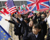 Children hold flags from G7 countries in the wind as the foreign ministers visit Hiroshima Peace Memorial Park in Hiroshima, western Japan, Monday, April 11, 2016. (Jonathan Ernst/Pool Photo via AP)