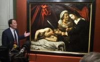 Auction officer Marc Labarbe presents the painting to the media in Paris, Tuesday, April 12, 2016. A 400-year-old painting that might have been executed by Italian master Caravaggio and could be worth more than 100 million euros has been found in an attic in Southern France.The picture, whose authenticity has not been established, had been left for more than 150 years in a property in the outskirts of Toulouse. (AP Photo/Michel Euler)