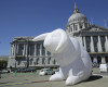 A large illuminated rabbit installed at Civic Center Plaza as part of an art piece entitled "Intrude" by Australian artist Amanda Parer is shown across from City Hall in San Francisco, Tuesday, April 5, 2016. To prevent the kind of vandalism that hit Super Bowl 50 artwork earlier this year, the bunnies will get 24-hour security from now until the exhibit ends on April 25. (AP Photo/Jeff Chiu)