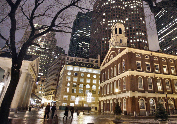 FILE - In this Feb. 22, 2007 file photo, Faneuil Hall, right, one of the sites on Boston's Freedom Trail, sits among buildings on an evening in downtown in Boston. With scientists forecasting sea levels to rise by anywhere from several inches to several feet by 2100, historic structures and coastal heritage sites around the world are under threat. A multidisciplinary conference is scheduled to convene in Newport, R.I., this week to discuss preserving those structures and neighborhoods that could be threatened by rising seas. (AP Photo/Michael Dwyer, File)