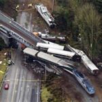  Cars from an Amtrak train that derailed above lie spilled onto Interstate 5, Monday, Dec. 18, 2017, in DuPont, Wash. The Amtrak train making the first-ever run along a faster new route hurtled off the overpass Monday near Tacoma and spilled some of its cars onto the highway below, killing several people, authorities said. (AP Photo/John Froschauer)