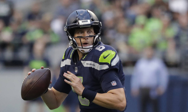 Seattle Seahawks quarterback Austin Davis looks to pass against the Oakland Raiders during the firs...