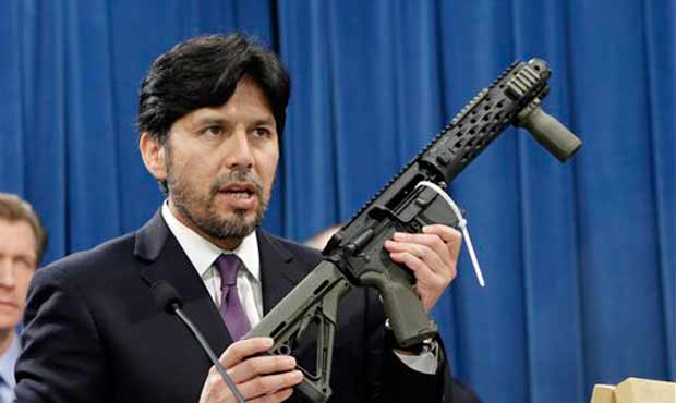 A homemade fully automatic rifle, confiscated by the Department of Justice, is displayed at a news ...