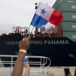 
              A spectator waves Panama flags as the Neopanamax cargo ship, Cosco Shipping Panama, crosses the new Agua Clara locks, part of the Panama Canal expansion project, near the port city of Colon, Panama, Sunday June 26, 2016. The ship carrying more than 9,000 containers entered the newly expanded locks that will double the Panama Canal's capacity in a multibillion-dollar bet on a bright economic future despite tough times for international shipping. (AP Photo/Moises Castillo)
            