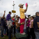 
              Spectators watch as the Neopanamax cargo ship, Cosco Shipping Panama prepares to cross the new new Agua Clara locks, part of the Panama Canal expansion project, near the port city of Colon, Panama, Sunday June 26, 2016. Authorities are hosting a big bash to inaugurate newly expanded locks that will double the Canal's capacity, as the country makes a multibillion-dollar bet on a bright economic future despite tough times for international shipping. (AP Photo/Moises Castillo )
            