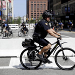
              Law enforcement on bikes patrol downtown Cleveland, Tuesday, July 19, 2016, during the second day of the Republican convention. (AP Photo/Patrick Semansky)
            