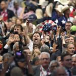 
              Delegates react as some delegates call for a roll call vote on the adoption of the rules during the opening day of the Republican National Convention in Cleveland, Monday, July 18, 2016. (AP Photo/Mark J. Terrill)
            