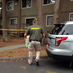 
              Investigators are seen at the apartment complex that has been tied to Arcan Cetin, the suspected Cascade Mall shooter, in Oak Harbor, Wash., Sunday, Sept. 25, 2016. Authorities carried boxes from a rear, upstairs apartment in the four-unit building. (AP Photo/Martha Bellisle)
            