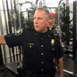 Acting Captain Greg Sackman, north precinct commander, shows the member-only gym in the basement of the north precinct. (Josh Kerns/KIRO Radio)