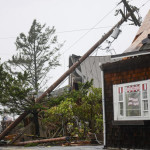 Storm debris lays along Laneda Ave, on Friday, Oct. 14, 2016, in Manzanita, Ore. A tornado struck the Oregon beach town as strong winds and heavy rain walloped the Pacific Northwest, leaving thousands without power as utility crews prepare for what's expected to be an even rougher storm on Saturday. (Danny Miller/Daily Astorian via AP)
