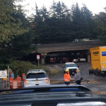 State and city officials, as well as law enforcement, wait outside an entrance to the "Jungle" Tuesday morning. (KIRO 7)