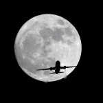 
              An American Airlines passenger plane passes in front of the moon, as seen from Whittier, Calif., Sunday, Nov. 13, 2016. Monday morning's supermoon will be the closet a full moon has been to the Earth since Jan. 26, 1948. (AP Photo/Nick Ut)
            