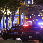 
              Police cars are staged at the scene of a shooting Wednesday, Nov. 9, 2016, in downtown Seattle. Authorities say a man escaped on foot after firing into a crowd and wounding five people outside a convenience store in downtown Seattle.   (AP Photo/Ted S. Warren)
            