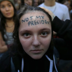 
              Clair Sheehan has the words "Not My President" written on her forehead as she takes part in a protest against the election of President-elect Donald Trump, Wednesday, Nov. 9, 2016, in downtown Seattle. (AP Photo/Ted S. Warren)
            