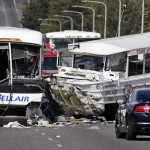 
              FILE - In this Sept. 24, 2015, file photo, a "Ride the Ducks" amphibious tour bus, right, and a charter bus remain at the scene of a fatal collision on the Aurora Bridge in Seattle. The National Transportation Safety Board meets Tuesday, Nov. 15, 2016, to determine the probable cause of the crash of the Ride the Ducks vehicle after it crossed the center line into oncoming traffic while driving over the bridge. It hit a charter bus full of college students, killing five. (AP Photo/Elaine Thompson, File)
            