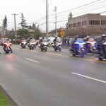 Tacoma police and other emergency service personnel take part in a processional for Tacoma Police Officer Reginald Gutierrez who was shot and killed two days earlier. (KIRO 7) 