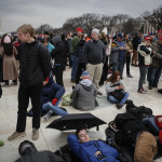 
              Spectators gather on the National Mall in Washington, Friday, Jan. 20, 2017, before the presidential inauguration of Donald Trump. (AP Photo/John Minchillo)
            