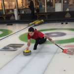 Charlie Anthe throws a rock at the Granite Curling Club in Seattle. (Josh Kerns/Kiro Radio)