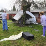 Jim Jenkins, left, and Kathi Haight, inspect damage caused by a tornado that lifted a shed and other debris strewn around the neighborhood after a tornado touched down, Thursday, Jan. 10, 2008 in Vancouver, Wash. A tornado downed power lines, uprooted trees, sent shopping carts flying into cars, and destroyed about 50 rowing shells moored at lakeside Thursday in Vancouver.  (AP Photo/The Columbian, Troy Wayrynen)