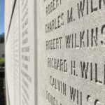 The Space Needle looms over the memorial wall at Memorial Stadium. (Feliks Banel)