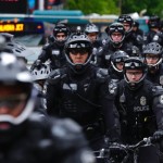 Seattle Police Officers stage near a May Day protest, Monday, May 1, 2017, in Seattle.  Immigrant and union groups marched in cities across the United States on Monday, to mark May Day and protest against President Donald Trump's efforts to boost deportations. The day has become a rallying point for immigrants in the U.S. since demonstrations were held in 2006 against a proposed immigration enforcement bill. (AP Photo/Ted S. Warren)