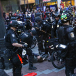 Seattle Police officers surround a man as they make an arrest, Monday, May 1, 2017, during a May Day protest in Seattle. (AP Photo/Ted S. Warren)