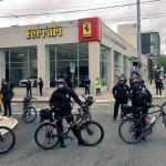 Seattle police line the streets of Seattle as May Day marchers move through the streets. (Josh Kerns, KIRO Radio)