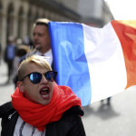 
              A far-right supporter marches next to French flag near the statue of Joan of Arc for his traditional march, Monday May 1, 2017, in Paris. France's tense presidential race is colliding with May Day labor marches in a campaign dominated by worries over jobs and seen as a test of populism's global appeal. (AP Photo/Thibault Camus)
            