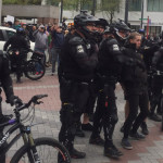 Seattle police detain a man at Westlake Park on May 1, 2017. (Josh Kerns, KIRO Radio)