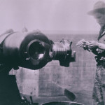 A soldier inspects the open breech of a 10” gun at Fort Stevens.  (Courtesy Gayle Denman)
