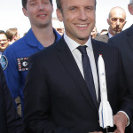 French President Emmanuel Macron poses with a model of Ariane 6 with French astronaut Thomas Pesquet while visiting the Paris Air Show in Le Bourget, north of Paris, Monday, June 19, 2017. The Ariane 6 is a launch vehicle under development by the European Space Agency (ESA), with a first test flight scheduled for 2020. (AP Photo/Michel Euler, Pool)