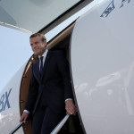 French President Emmanuel Macron leaves a Falcon 8X while visiting the Paris Air Show in Le Bourget, north of Paris, Monday, June 19, 2017. Macron landed Monday at the Bourget airfield in an Airbus A400-M military transport plane to launch the aviation showcase, where the latest Boeing and Airbus passenger jets will vie for attention with an F-35 warplane, drones and other and high-tech hardware. (AP Photo/Michel Euler)
