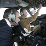 French President Emmanuel Macron is seated in the cockpit of an Airbus A400M turboprop transport plane while flying from Villacoublay military airbase near Paris to Le Bourget airport, north of Paris, Monday, June 19, 2017. Macron landed Monday at the Bourget airfield in an Airbus A400-M military transport plane to launch the aviation showcase, where the latest Boeing and Airbus passenger jets will vie for attention with a F-35 warplane, drones and other and high-tech hardware. (AP Photo/Michel Euler, Pool)
