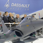 French President Emmanuel Macron, second left, listens to Dassault Aviation CEO Eric Trappier, center, while visiting the Paris Air Show in Le Bourget, north of Paris, Monday, June 19, 2017. Macron landed at the Bourget airfield in an Airbus A400-M military transport plane to launch the aviation showcase. At left is French politician Olivier Dassault, his father Dassault chairman Serge Dassault stands at second right, and Charles Edelstenne, general manager of Dassault Group. (AP Photo/Michel Euler)