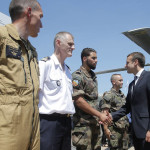 French President Emmanuel Macron, second right, shakes hands with French soldiers as he visits the Paris Air Show in Le Bourget, north of Paris, Monday, June 19, 2017. Macron landed at the Bourget airfield in an Airbus A400-M military transport plane to launch the aviation showcase. (AP Photo/Michel Euler)