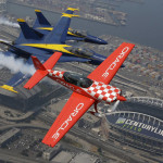 Stunt pilot Sean D. Tucker, right, flies his Team Oracle Extra 300L in formation with U.S. Navy Blue Angels' Lt. Tyler Davies, left, and Cmdr. Frank Weisser, center, Thursday, Aug. 3, 2017, above CenturyLink Field in Seattle in preparation for their weekend performances in the Seafair Air Show on Saturday and Sunday, Aug. 5-6, 2017. (AP Photo/Ted S. Warren)
