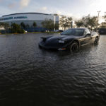 
              A car sits in a flooded parking lot outside the Germain Arena, which was used as an evacuation shelter for Hurricane Irma, which passed through yesterday, in Estero, Fla., Monday, Sept. 11, 2017. (AP Photo/Gerald Herbert)
            